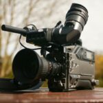 black video camera on brown wooden table