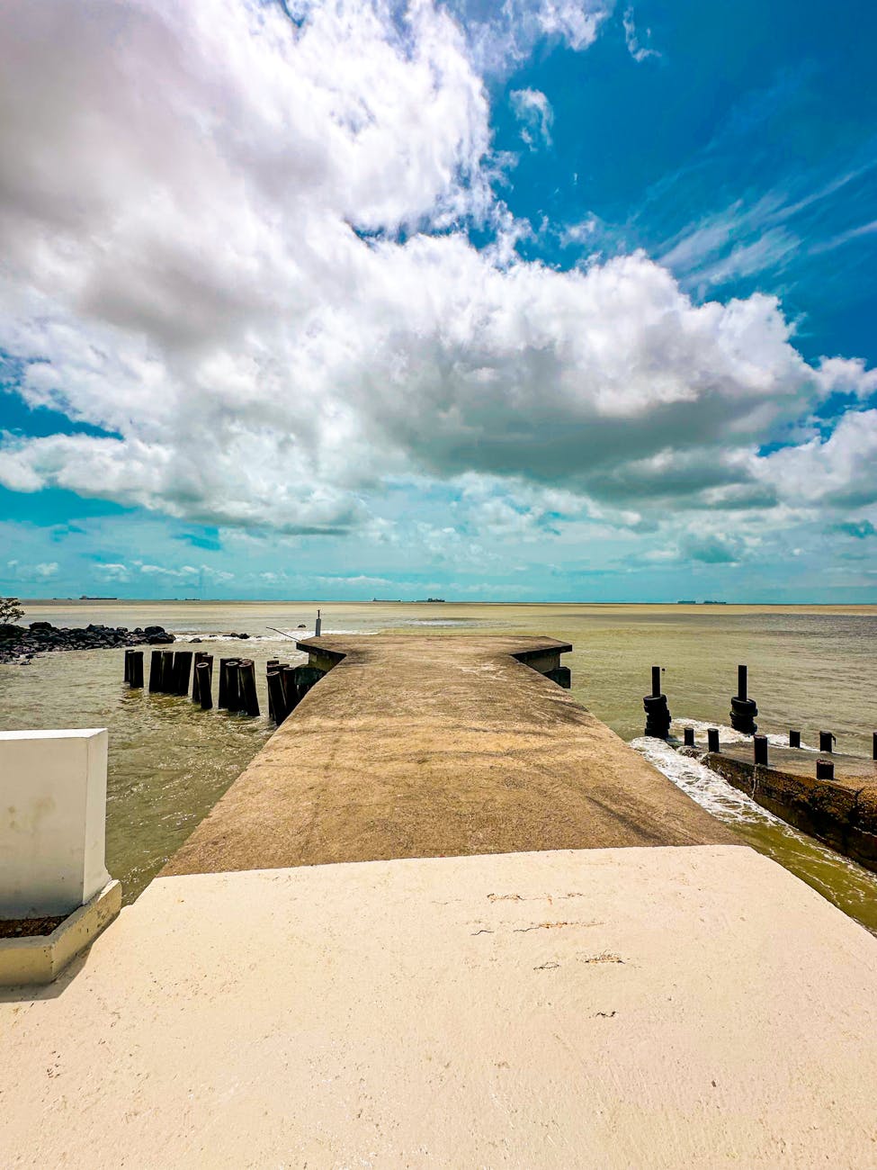 scenic coastal pier with dramatic cloudy sky